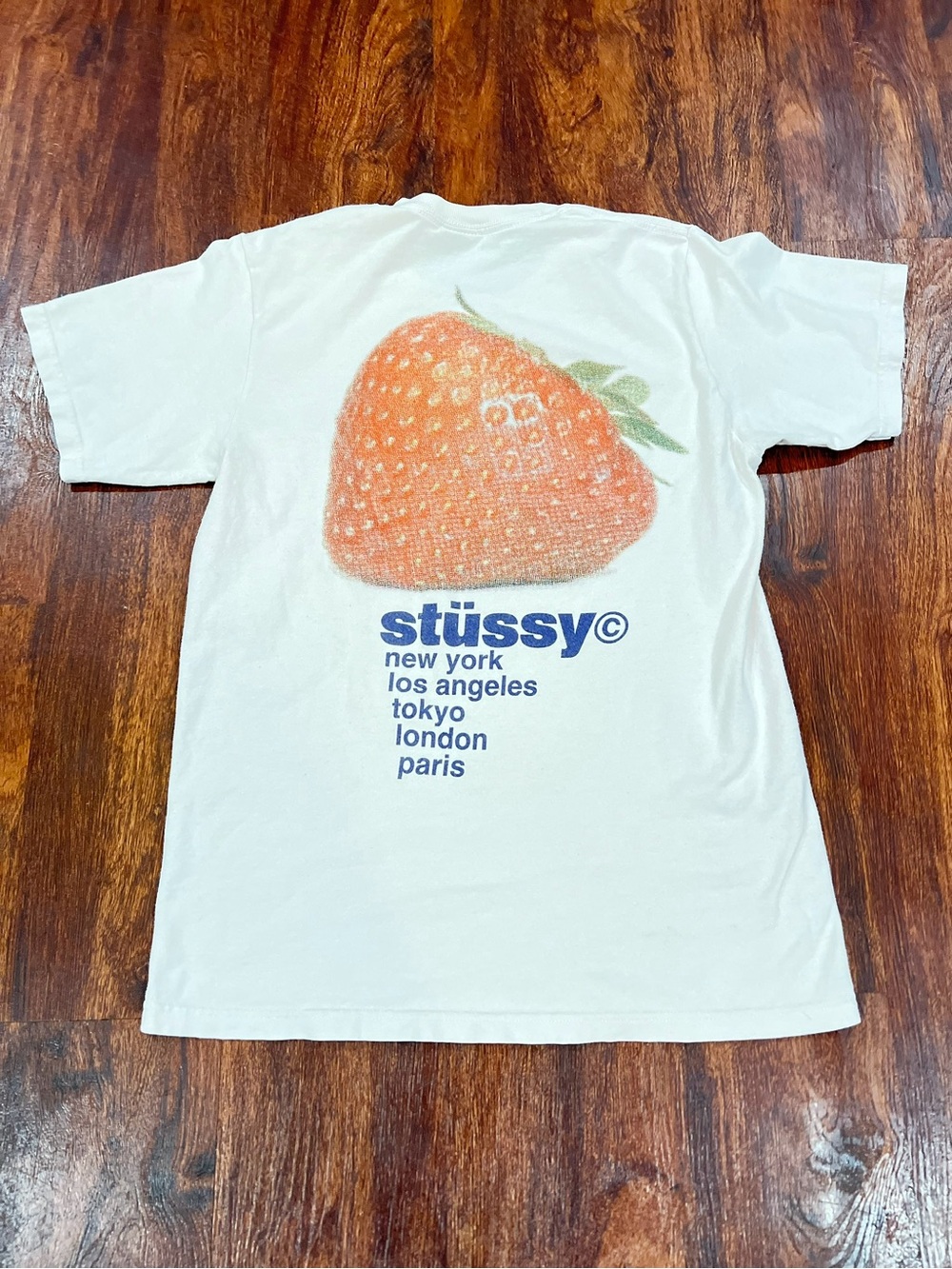Stussy White Tee with Orange Strawberry and Blue Logo